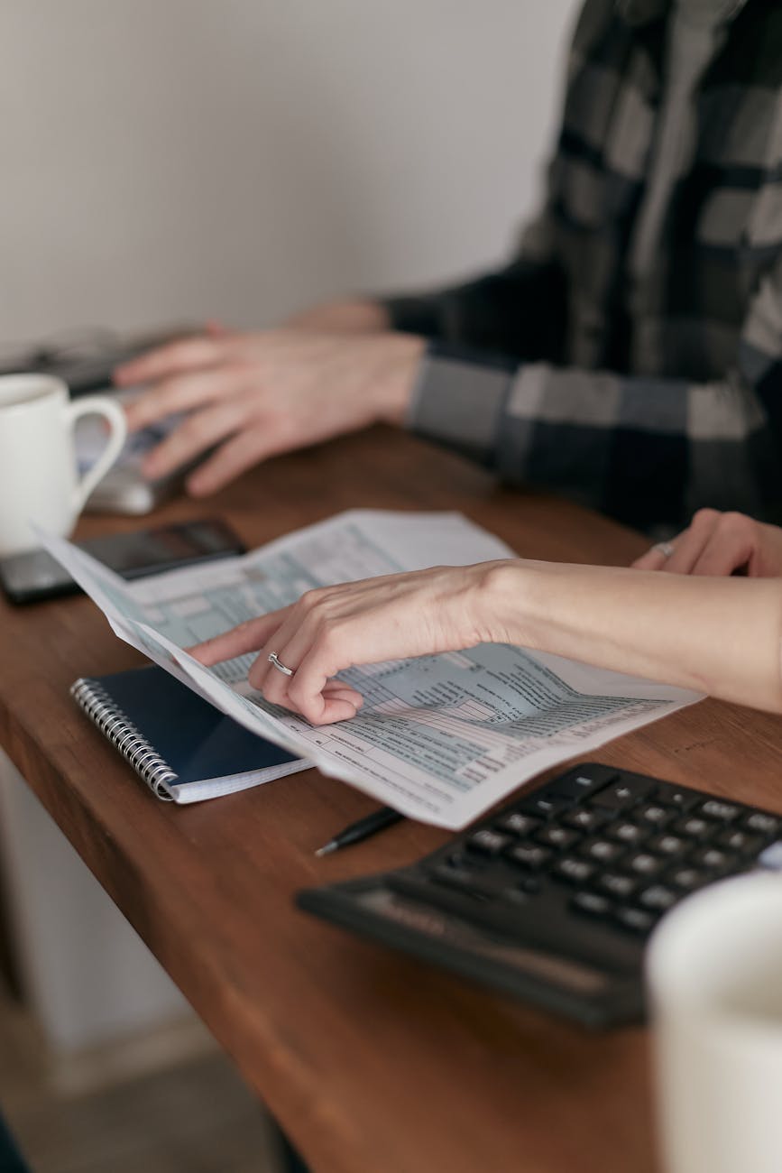 Hands reviewing documents together on a desk.